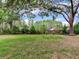 Mature trees and a well-maintained lawn enhance the beauty of this serene backyard space at 7216 N Mobley Rd, Odessa, FL 33556