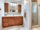 Bathroom featuring a wooden vanity with drawers and decorative lights at 7216 N Mobley Rd, Odessa, FL 33556