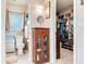Bathroom with a cabinet, toilet, and a view to the walk-in closet with storage at 7216 N Mobley Rd, Odessa, FL 33556