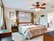 Cozy bedroom with a large bed, a ceiling fan and side tables creating a tranquil retreat for relaxation at 7216 N Mobley Rd, Odessa, FL 33556