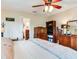 Bedroom with a bed, wooden dresser, and an en-suite bathroom access at 7216 N Mobley Rd, Odessa, FL 33556