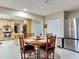 The dining room has a wooden table that adjoins the kitchen with stainless steel appliances at 7216 N Mobley Rd, Odessa, FL 33556