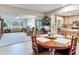 The dining room's wooden table adjoins the living room and kitchen with wood cabinetry at 7216 N Mobley Rd, Odessa, FL 33556