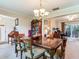 Dining room with glass top table and chairs, flowing into living area at 7216 N Mobley Rd, Odessa, FL 33556
