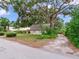 Quaint exterior of guest house and surrounding greenery provides privacy and curb appeal at 7216 N Mobley Rd, Odessa, FL 33556