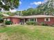 Well-manicured front yard of a cozy brick home, enhanced by vibrant green grass at 7216 N Mobley Rd, Odessa, FL 33556