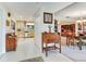 Bright hallway featuring a dining room, desk, and glimpses of the kitchen at 7216 N Mobley Rd, Odessa, FL 33556