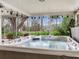 Relaxing covered hot tub with a view of lush greenery, perfect for unwinding in privacy and comfort at 7216 N Mobley Rd, Odessa, FL 33556