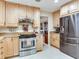 Bright kitchen features stainless steel appliances and light wood cabinetry at 7216 N Mobley Rd, Odessa, FL 33556