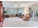 The living room has carpeted floors, a ceiling fan and sliding glass doors at 7216 N Mobley Rd, Odessa, FL 33556