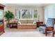 Bright living room showcasing a large window, comfortable sofa, and side tables at 7216 N Mobley Rd, Odessa, FL 33556