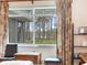Bedroom window featuring beautiful lake and forest views with stylish curtains and blinds at 7216 N Mobley Rd, Odessa, FL 33556