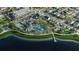 Aerial view of the community showcasing the pool, tennis courts, lake, and residential buildings at 7610 Addison Ave, Bradenton, FL 34210