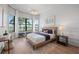 Bright bedroom features a wood-frame bed, modern decor, and large windows with outside views at 7610 Addison Ave, Bradenton, FL 34210