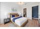 Well-lit bedroom features a wood-frame bed, modern decor, and an ensuite bathroom at 7610 Addison Ave, Bradenton, FL 34210