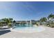 Resort-style community pool with fountains, palm trees, and lounge seating at 7610 Addison Ave, Bradenton, FL 34210