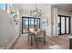 Modern dining room features a stylish light fixture, dining table with seating for six, and sliding glass doors at 7610 Addison Ave, Bradenton, FL 34210
