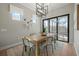 Modern dining room features a stylish light fixture, dining table with seating for six, and sliding glass doors at 7610 Addison Ave, Bradenton, FL 34210