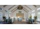 Beautiful dining room with high ceilings, wood beams, and elegant tables set for a meal at 7610 Addison Ave, Bradenton, FL 34210