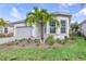 Beautiful single-story home features manicured lawn, gray tiled roof and lush landscaping at 7610 Addison Ave, Bradenton, FL 34210