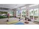 Bright fitness area with open air feature, fitness equipment, yoga mats, and exterior garden view at 7610 Addison Ave, Bradenton, FL 34210