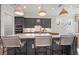 Stylish kitchen island boasts bar stool seating, pendant lighting, and sleek appliances at 7610 Addison Ave, Bradenton, FL 34210