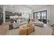 Bright living room features a modern sectional sofa, stylish coffee table, and an open layout to the kitchen at 7610 Addison Ave, Bradenton, FL 34210