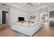 Comfortable living room features a large sectional sofa, modern ceiling fan, and stylish shiplap accent wall at 7610 Addison Ave, Bradenton, FL 34210