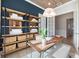 Bright office space with natural wood desk, shelving, and stylish decor at 7610 Addison Ave, Bradenton, FL 34210