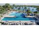 Large pool area featuring palm trees, lounge chairs, and a view of the lake in the background at 7610 Addison Ave, Bradenton, FL 34210