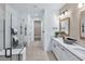 Modern bathroom featuring double sinks, white cabinetry, and a glass-enclosed shower at 7614 Addison Ave, Bradenton, FL 34210