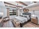 Comfortable bedroom featuring wood beam ceilings and an eye-catching decorative lighting fixture at 7614 Addison Ave, Bradenton, FL 34210