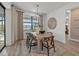 Bright dining room with views, stylish furnishings, and seamless connection to the outdoor space at 7614 Addison Ave, Bradenton, FL 34210