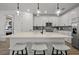 Bright kitchen with white cabinetry, stainless steel appliances, and a central island with barstool seating at 7614 Addison Ave, Bradenton, FL 34210