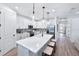 Modern kitchen featuring white cabinets, a large island with seating, and stainless steel appliances at 7614 Addison Ave, Bradenton, FL 34210