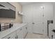 Well-organized laundry room with ample counter space, white cabinetry, and a modern aesthetic at 7614 Addison Ave, Bradenton, FL 34210