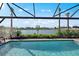 Beautiful screened pool with a view of the serene lake and lush landscaping at 7614 Addison Ave, Bradenton, FL 34210