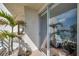Relaxing outdoor space with tiled floor, potted palm, and sliding glass doors at 7922 Sailboat Key S Blvd # 608, South Pasadena, FL 33707