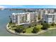 Beautiful waterfront condominium building featuring lush landscaping, covered parking, and waterfront views at 7922 Sailboat Key S Blvd # 608, South Pasadena, FL 33707