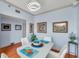 Bright dining area featuring a white table, stylish decor, and light blue walls with white trim and hardwood floors at 7922 Sailboat Key S Blvd # 608, South Pasadena, FL 33707