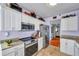 Efficient kitchen layout with stainless steel appliances, granite countertops, and white cabinetry for ample storage at 7922 Sailboat Key S Blvd # 608, South Pasadena, FL 33707