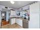 Bright kitchen with white cabinetry, granite counters, and stainless steel appliances at 7922 Sailboat Key S Blvd # 608, South Pasadena, FL 33707