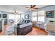Bright living room featuring wood floors, ceiling fans, and a sliding glass door to the balcony at 7922 Sailboat Key S Blvd # 608, South Pasadena, FL 33707