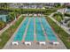 Aerial view of shuffleboard courts with clearly marked lanes and surrounding landscaping at 7922 Sailboat Key S Blvd # 608, South Pasadena, FL 33707