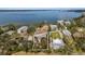 Overhead view focuses on a home in Palmetto, Florida, surrounded by mature trees and neighboring properties at 824 35Th Avenue W Dr, Palmetto, FL 34221