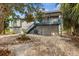 The backyard features mature trees, gravel landscape, and a stairway at 824 35Th Avenue W Dr, Palmetto, FL 34221