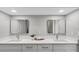 Bathroom featuring double sinks with a large countertop, updated cabinets, and modern mirrors at 824 35Th Avenue W Dr, Palmetto, FL 34221