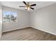 This bedroom features modern gray paint, wood-look floors, a ceiling fan, and a bright window at 824 35Th Avenue W Dr, Palmetto, FL 34221