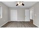 This bedroom boasts light gray walls, a ceiling fan, wood-look floors, and generous closet space at 824 35Th Avenue W Dr, Palmetto, FL 34221