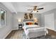 This bedroom features gray walls, ceiling fan, closet, and stylish lamps at 824 35Th Avenue W Dr, Palmetto, FL 34221